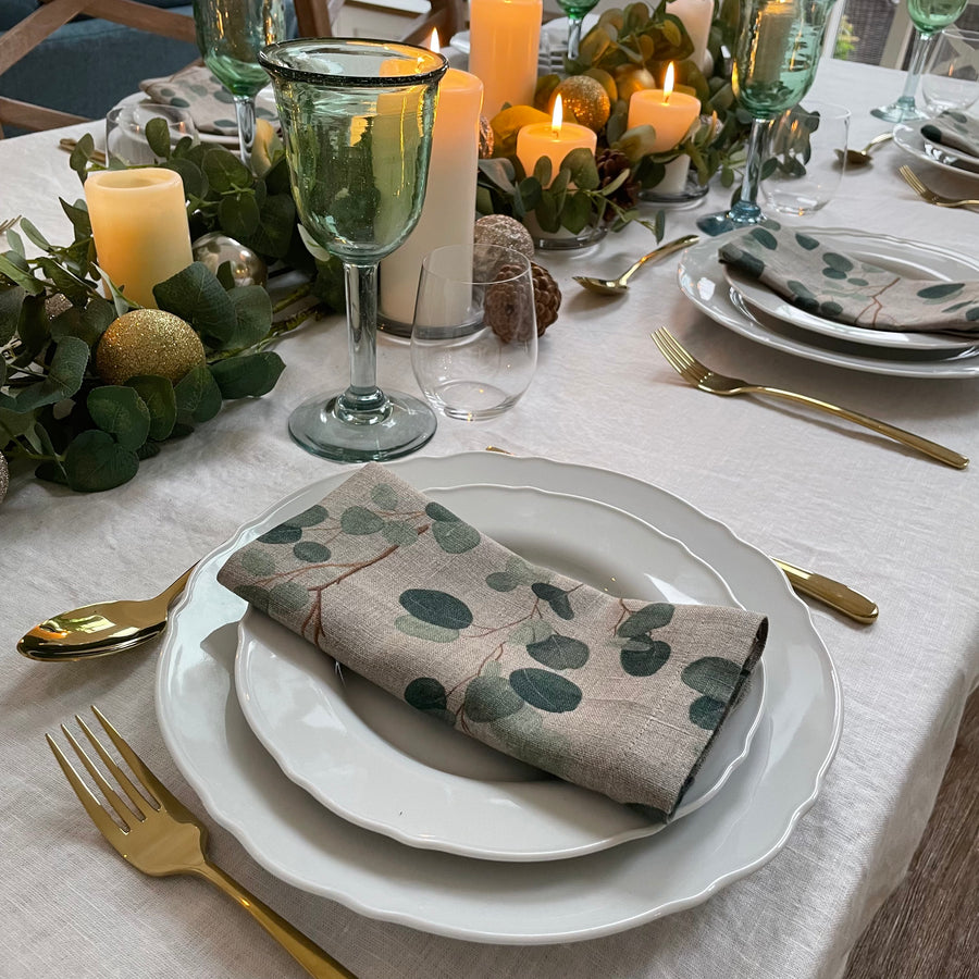 Eucalyptus print napkin on dining table with white tablecloth