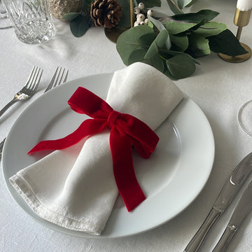 White napkin with red velvet bow
