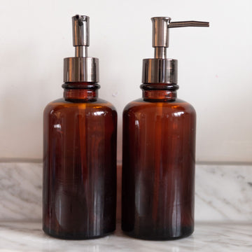 Pair of brown glass soap dispencers