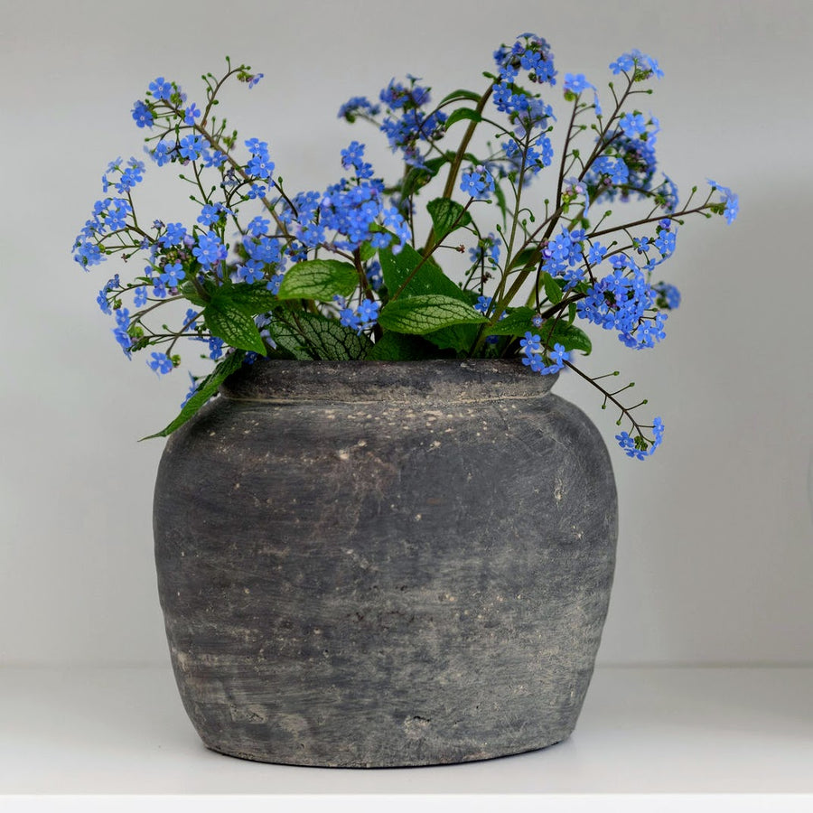 Grey vase with blue flowers