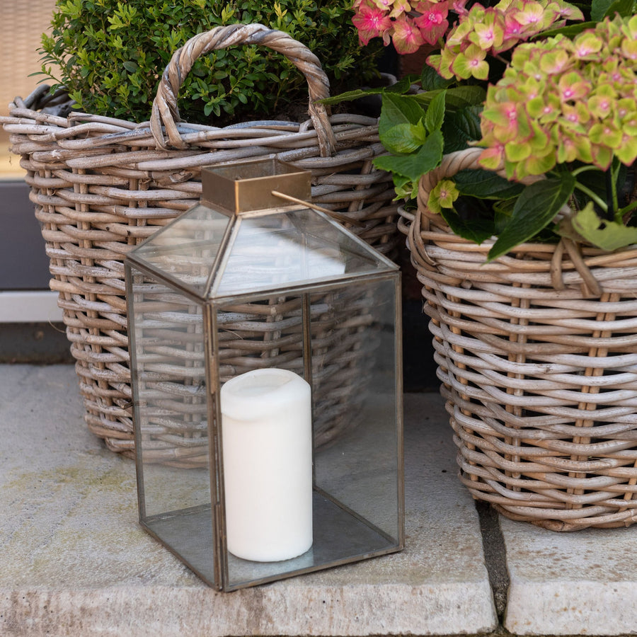 brass lantern styled outside beside plant pots