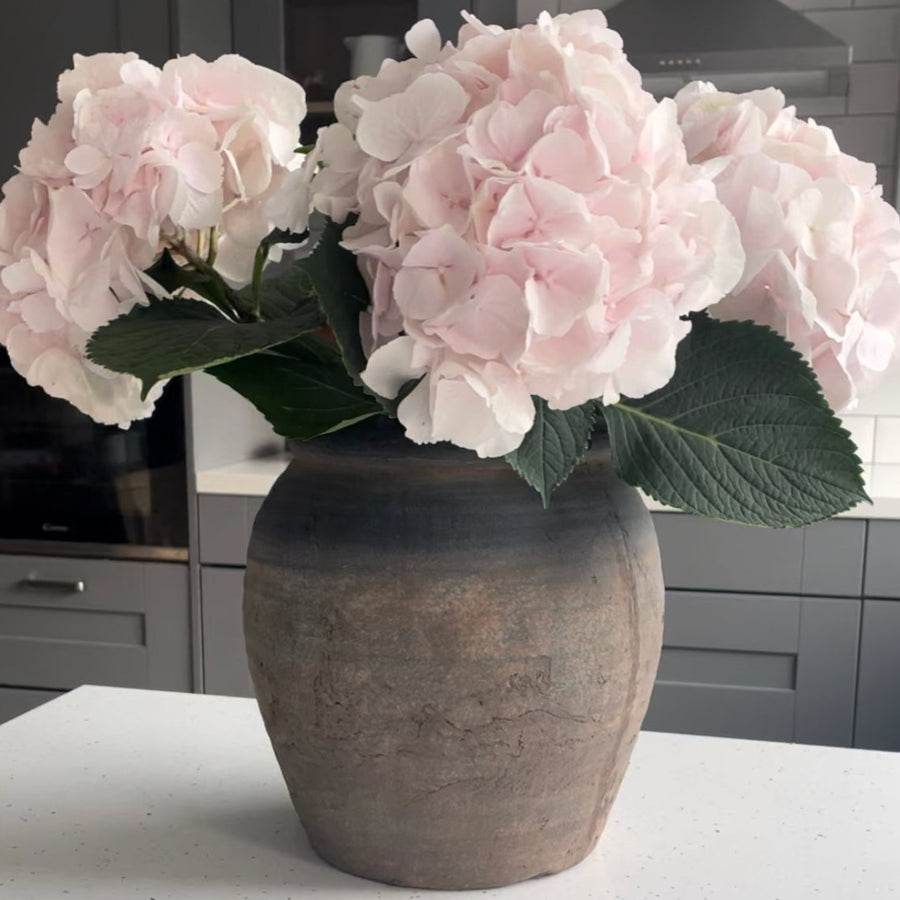 rustic concrete grey and brown vase with pink hydrangeas