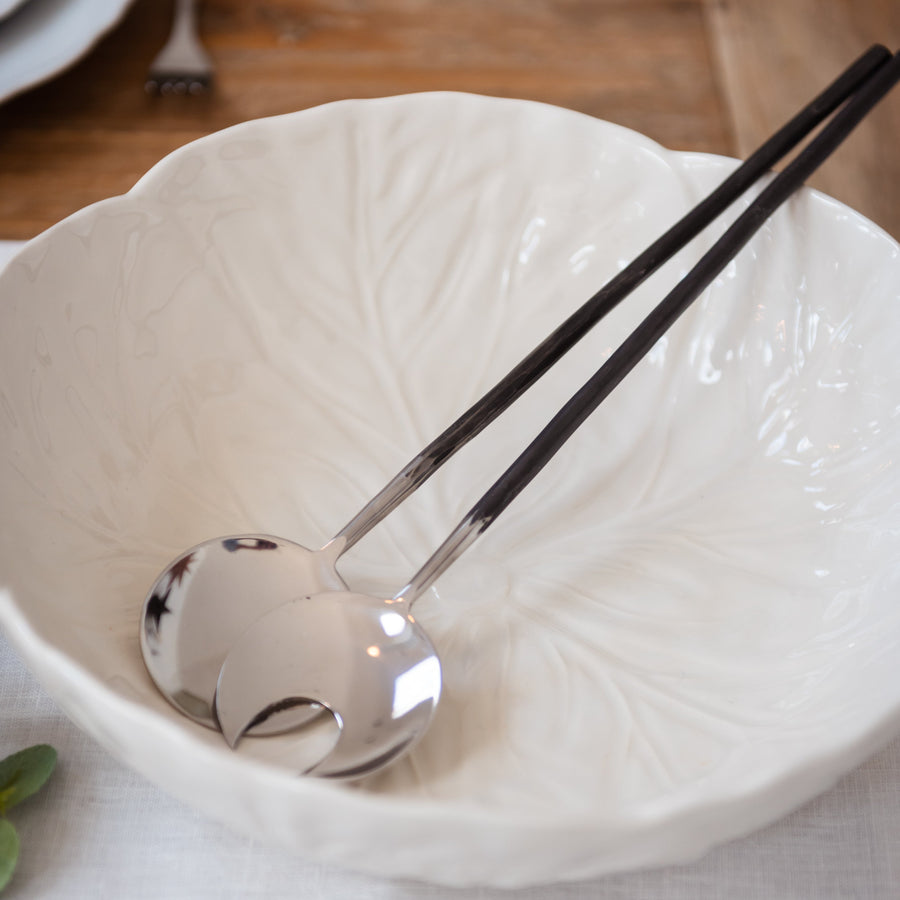 white salad bowl with a pair of servers