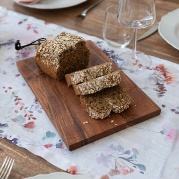 wooden board with a brown loaf