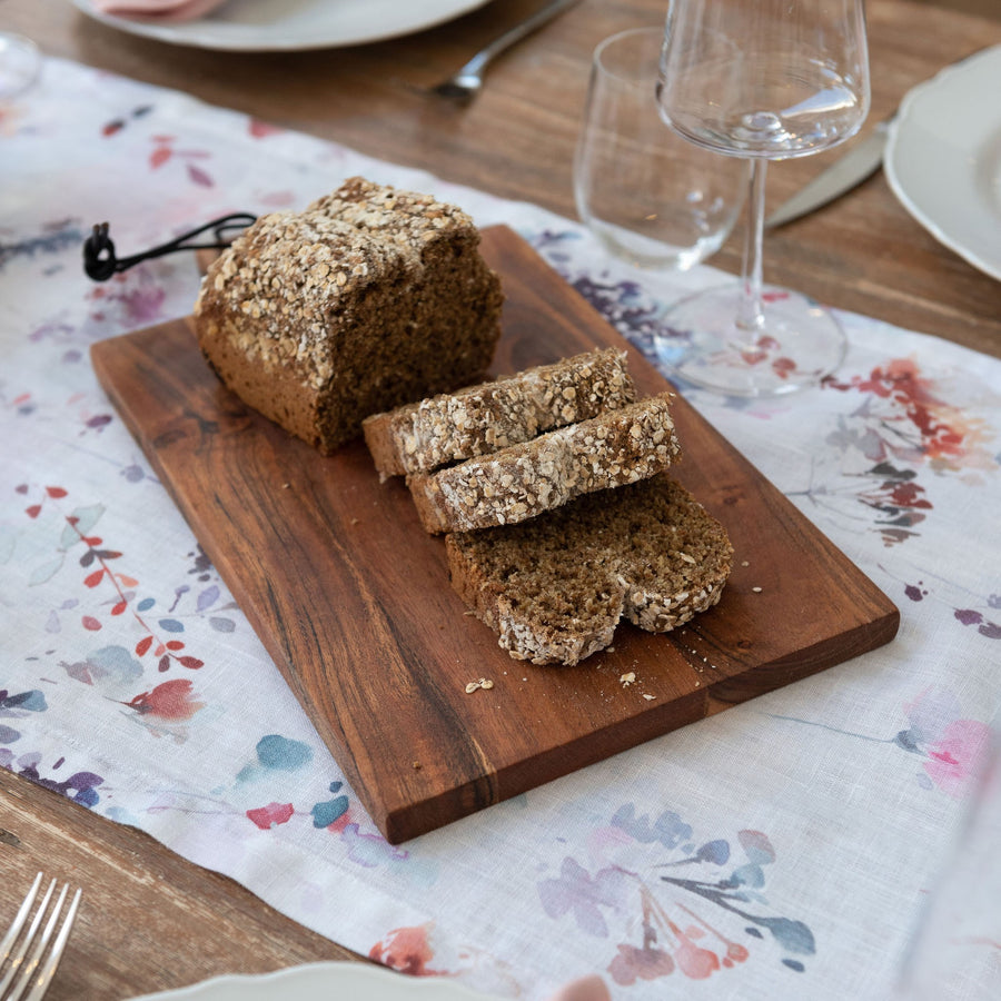 wooden board with a brown loaf