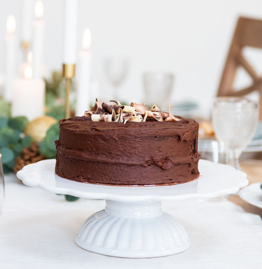 white cake stand with chocolate cake